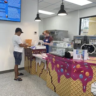 a man and a woman ordering ice cream