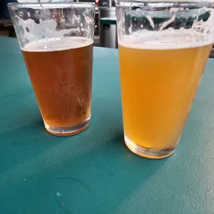 two glasses of beer on a table