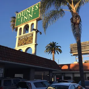 a palm tree in front of a restaurant