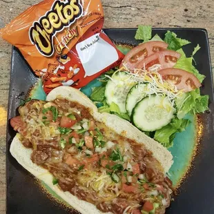 a hot dog, salad and chips