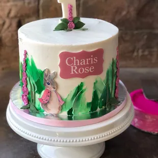 a cake decorated with a ladybug and flowers