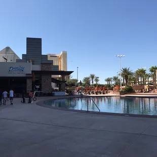 a pool with people walking around it