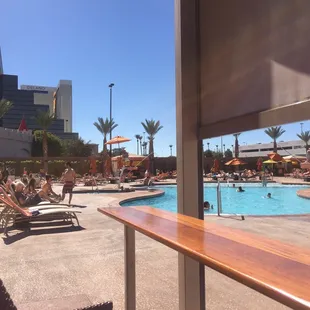 a pool with lounge chairs and umbrellas