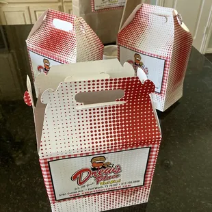 three takeout boxes on a kitchen counter