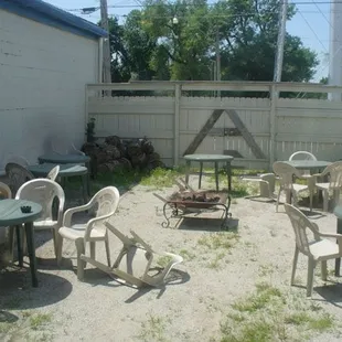 a patio with chairs and tables