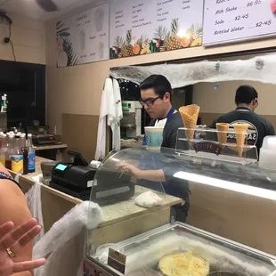 a woman standing in front of a counter