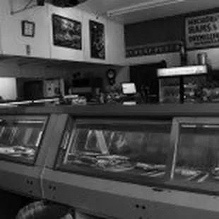 a black and white photo of a deli counter