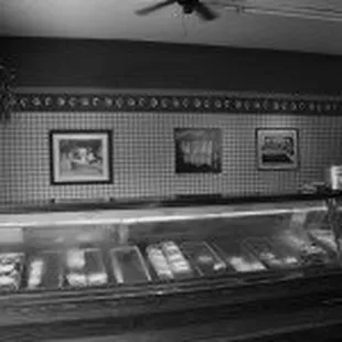 a black and white photo of a deli counter
