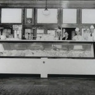 a woman standing in front of a display case