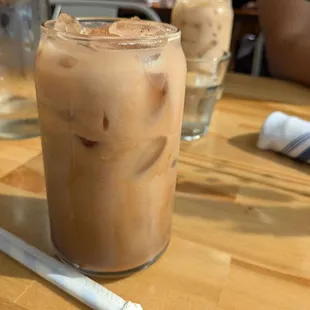 Iced mocha latte with 2% milk and iced chai in the background