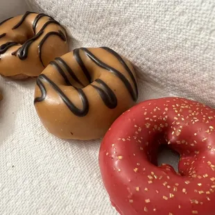 Tiger stripes/banana caramel donuts, raspberry sprinkles donuts