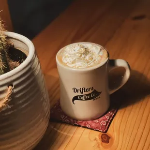 a mug of coffee and a cactus