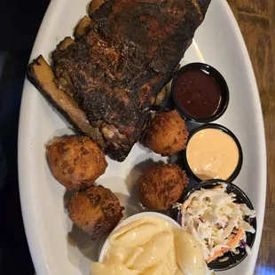 Excellent half a rack of St. Louis ribs with Mac n cheese, four hush puppies and Cole slaw.