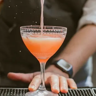 a bartender pouring a drink