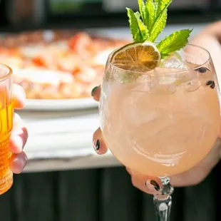 two people holding up drinks