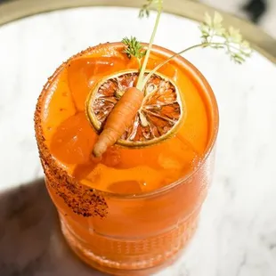 a glass of orange juice on a table