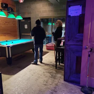 two people playing a game of pool