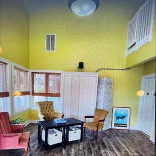 a living room with yellow walls
