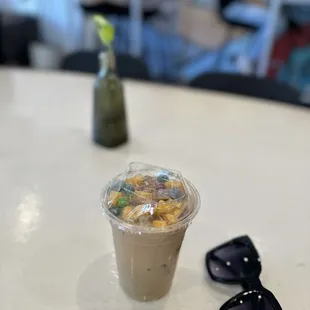 a cup of coffee and a pair of sunglasses on a table