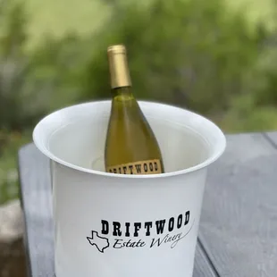a bottle of wine in a bucket