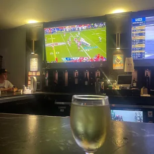 a glass of wine on a bar