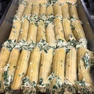 a pan of pasta with spinach and cheese