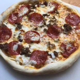a pepperoni pizza on a cutting board