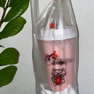 Large Strawberry Milk Tea with 100% sweetness and boba inside the cute bag packaging!