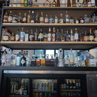 a variety of alcohol bottles on shelves