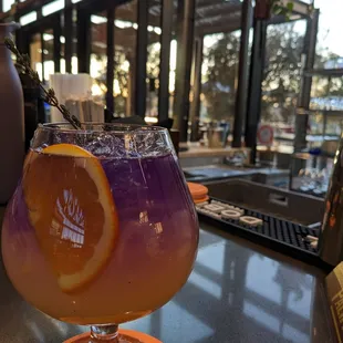 an orange and purple drink in a glass