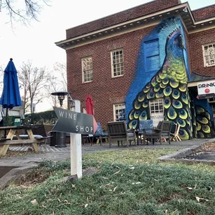 a peacock painted on the side of a building