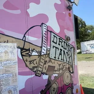 a pink camo truck parked in a field