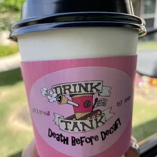 a hand holding a cup of coffee