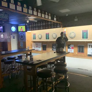 The first row of dart . There are about 12 machines to play darts with.