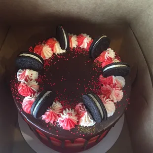 a chocolate cake with red and white frosting