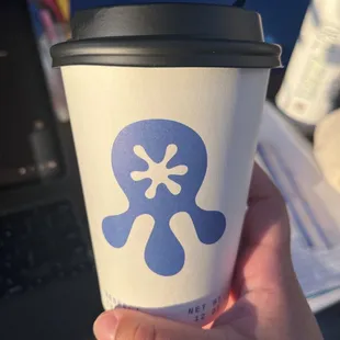 a skull and crossbone on a paper cup