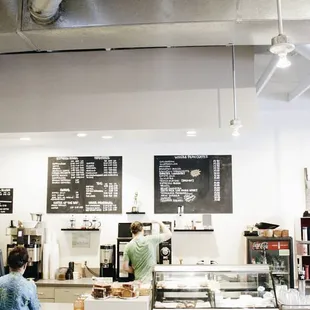 a woman standing in a coffee shop