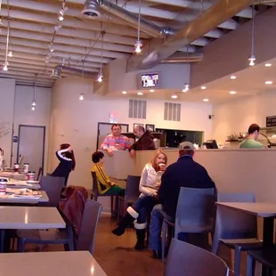 people sitting at tables in a coffee shop
