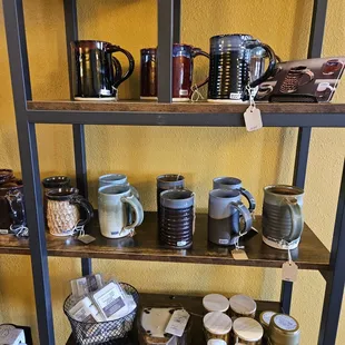 a shelf of coffee mugs