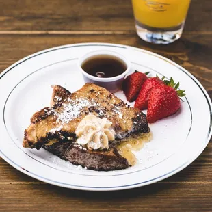 a plate of french toast and strawberries