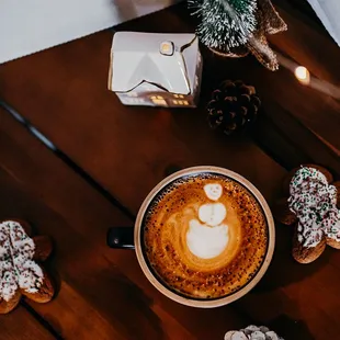 a cup of cappuccino on a wooden table