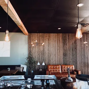 a coffee shop with a leather couch and a coffee table