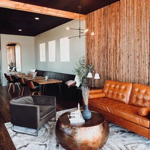 a living room with a brown leather couch