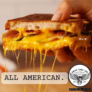  a hand holding a grilled cheese sandwich