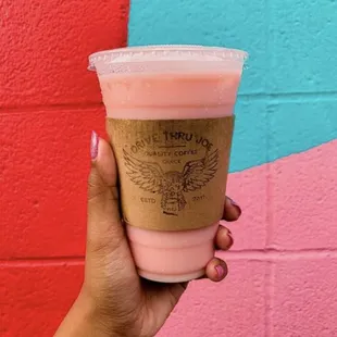 a hand holding a cup of coffee