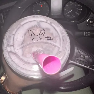 a pink cup with a spoon sticking out of it