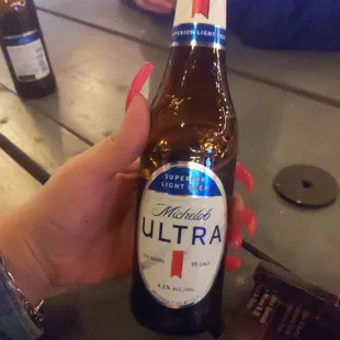 a person holding a bottle of ultra