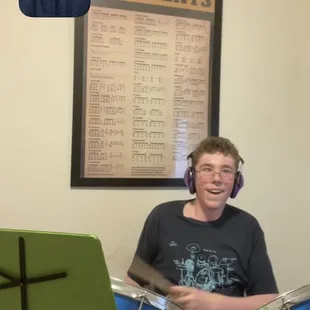 Chip Ritter with Liam Kincaid who is rocking out during his Virtual Drum Lesson