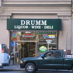 a truck parked in front of a liquor and deli store