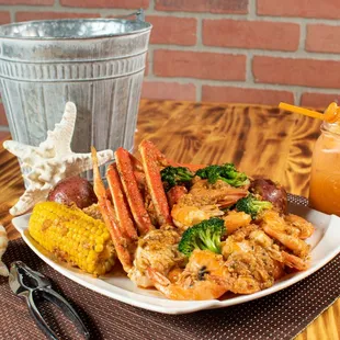 a plate of crab legs and corn on the cob